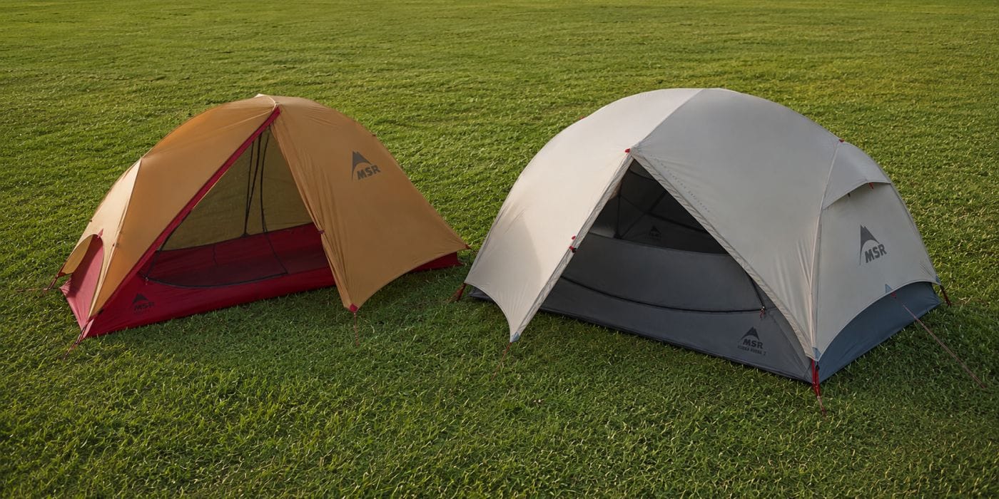 One-person and two-person backpacking tents compared at adjacent campsites