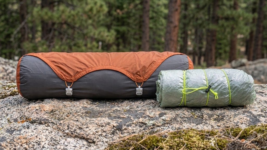 Packed freestanding tent and trekking pole shelter components compared
