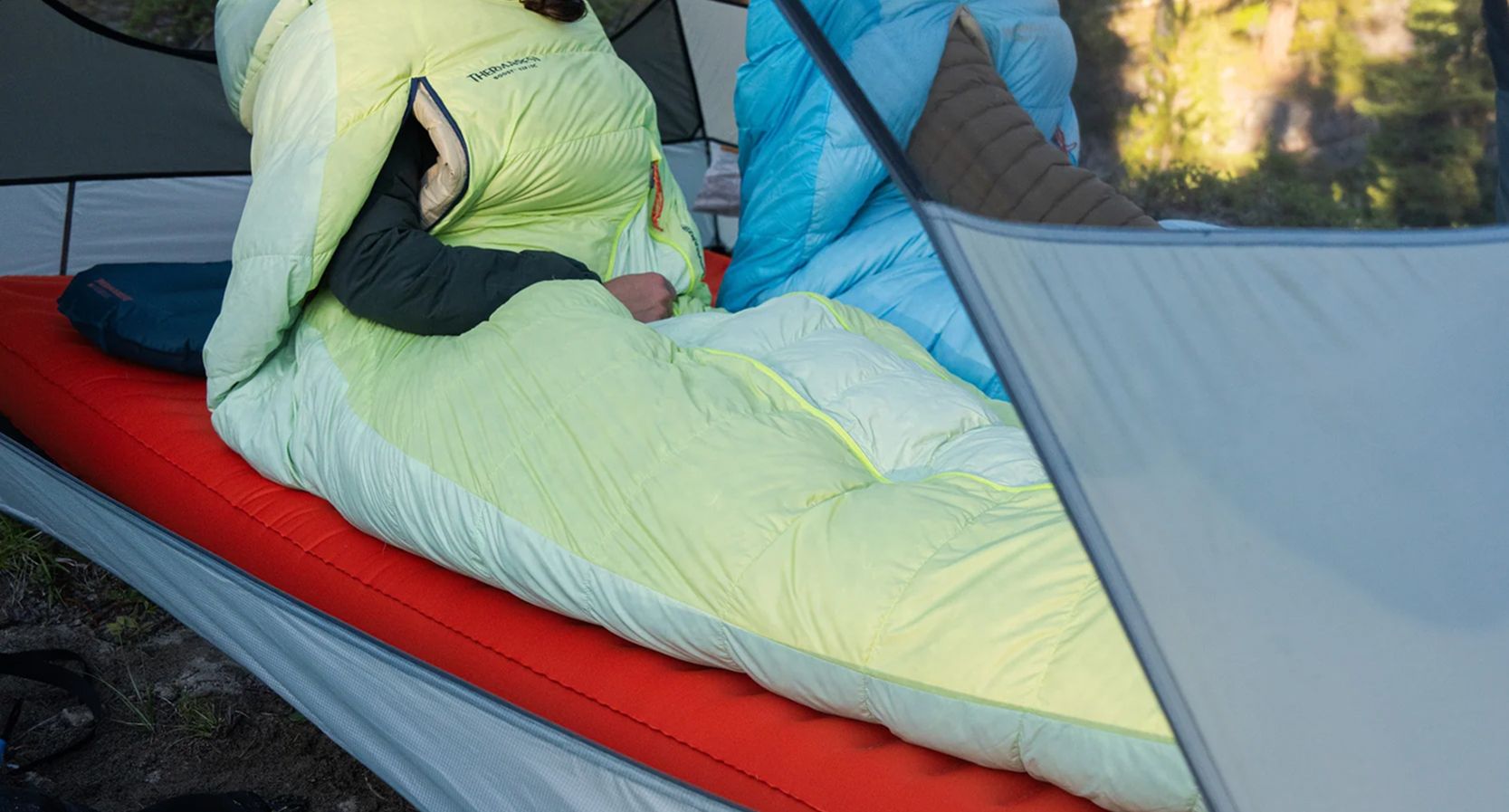 Sleeping pad, quilt, and backpacking sleep layers arranged together