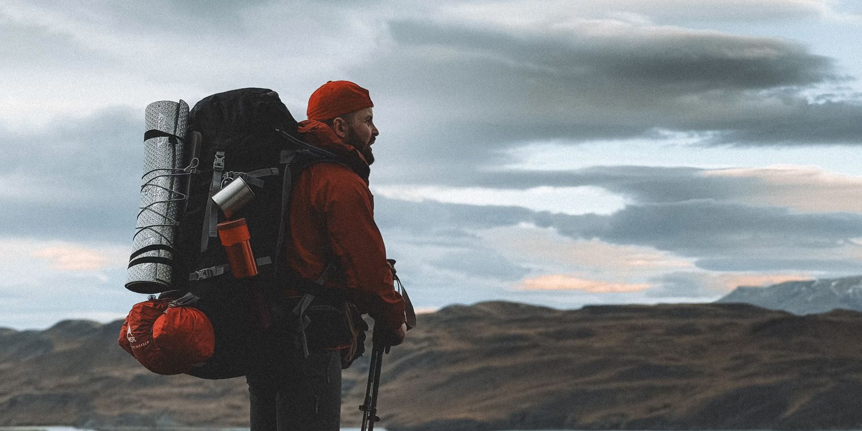 Backpacking pack beside laid-out overnight hiking gear